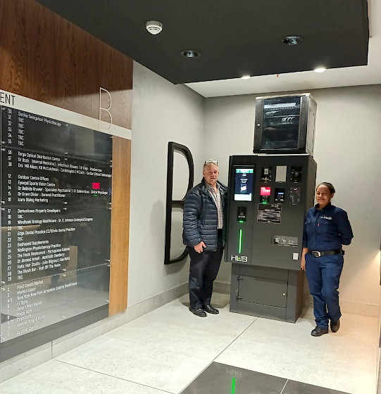 South Africa team and Director Barney Beukes in front of the APS pay on foot pay station during their site visit