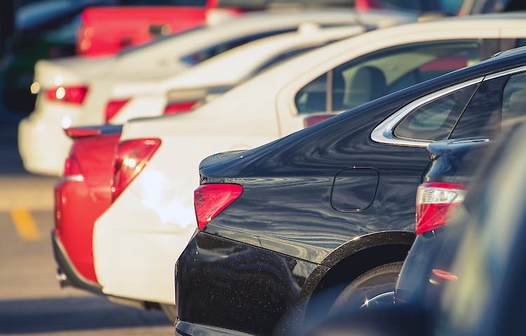 Some cars parked in a row in a parking